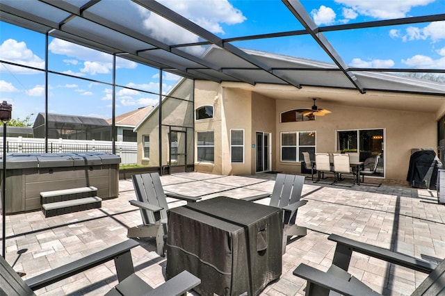 211 Tavestock Loop, Winter Springs, FL 32708 - view of patio / terrace with a hot tub, outdoor dining area, a ceiling fan, and glass enclosure