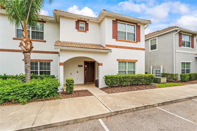 3193 Pequod Pl, Kissimmee, FL 34746 - view of property featuring a tile roof, stucco siding, and uncovered parking