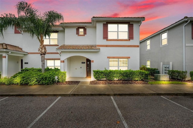 3193 Pequod Pl, Kissimmee, FL 34746 - view of front of house featuring stucco siding, a tiled roof, and uncovered parking