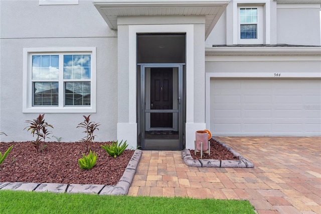 944 Benjamin Trl, Davenport, FL 33837 - entrance to property with stucco siding, a garage, and driveway