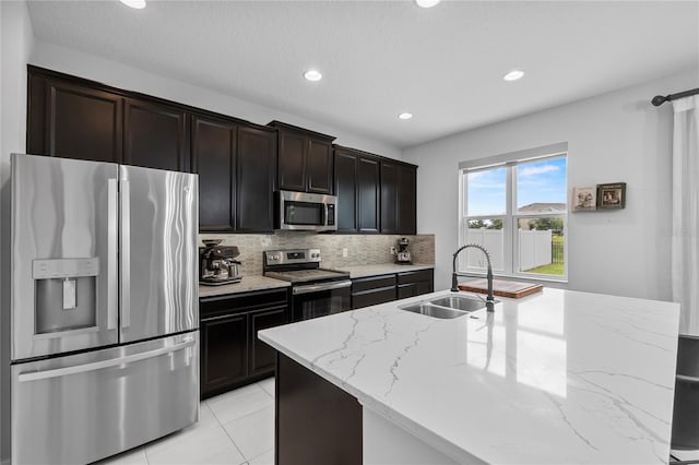 944 Benjamin Trl, Davenport, FL 33837 - kitchen featuring stainless steel appliances, tasteful backsplash, recessed lighting, light stone counters, and light tile patterned flooring