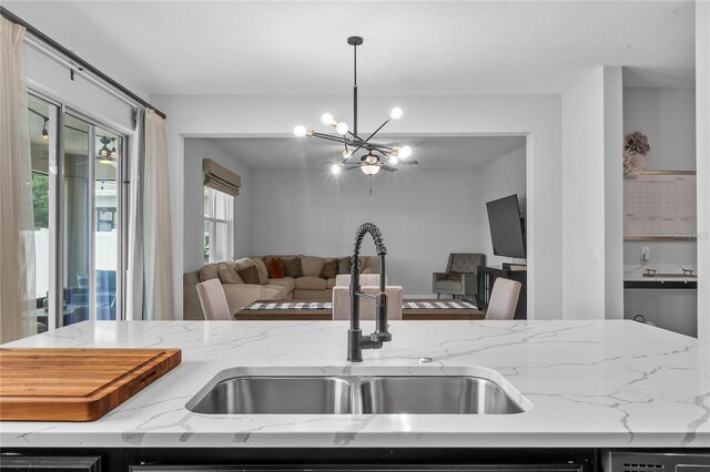 944 Benjamin Trl, Davenport, FL 33837 - kitchen featuring open floor plan, a chandelier, light stone counters, and decorative light fixtures