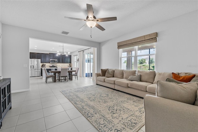 944 Benjamin Trl, Davenport, FL 33837 - living area with a chandelier, a ceiling fan, and light tile patterned flooring
