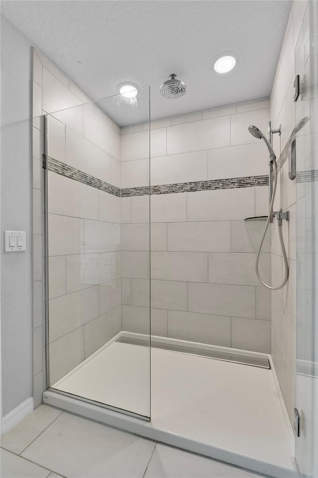 944 Benjamin Trl, Davenport, FL 33837 - bathroom with a stall shower, tile patterned floors, and a textured ceiling
