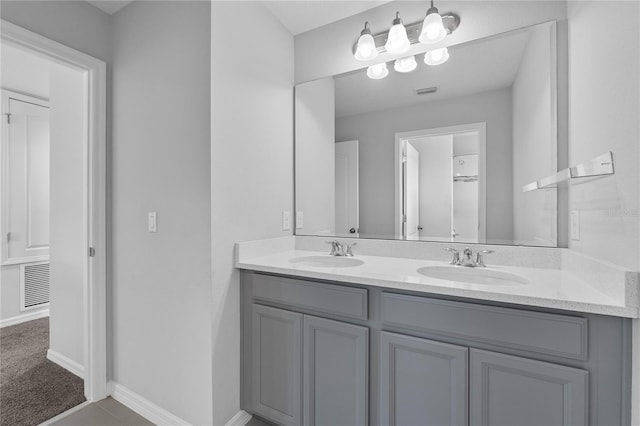 944 Benjamin Trl, Davenport, FL 33837 - full bathroom featuring double vanity and baseboards