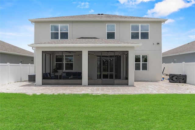 944 Benjamin Trl, Davenport, FL 33837 - back of property with a sunroom, a fenced backyard, stucco siding, and a patio