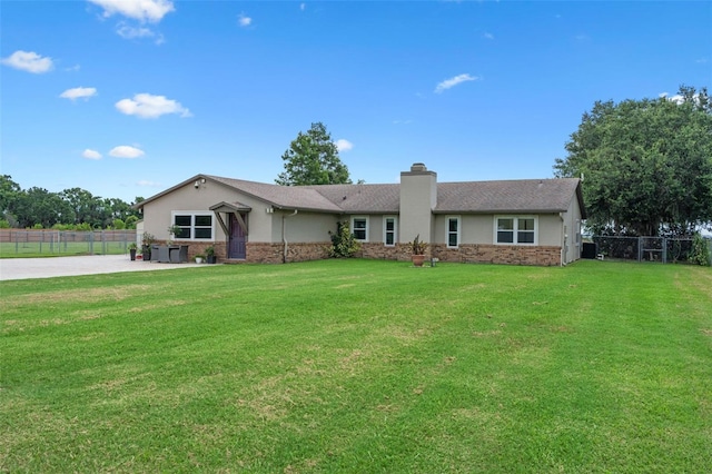 2921 Lake Tohopekaliga Blvd, Kissimmee, FL 34746 - ranch-style house with a chimney, brick siding, a patio, and stucco siding
