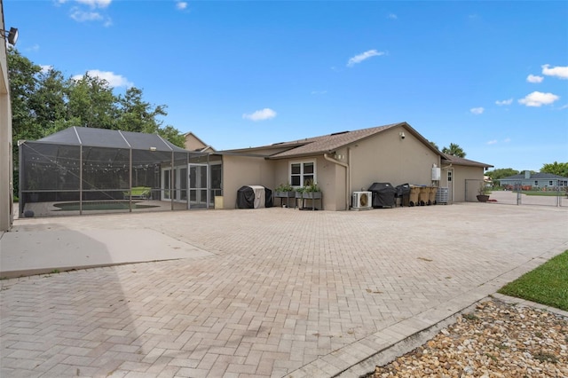 2921 Lake Tohopekaliga Blvd, Kissimmee, FL 34746 - back of house featuring stucco siding, a lanai, and a patio area