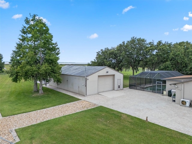 2921 Lake Tohopekaliga Blvd, Kissimmee, FL 34746 - detached garage featuring driveway and an outdoor pool