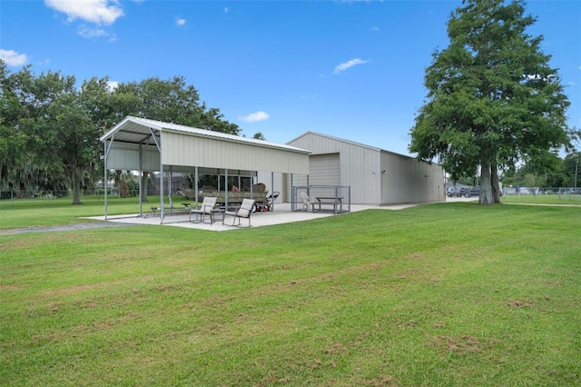 2921 Lake Tohopekaliga Blvd, Kissimmee, FL 34746 - back of house featuring an outdoor structure, a detached garage, and a pole building