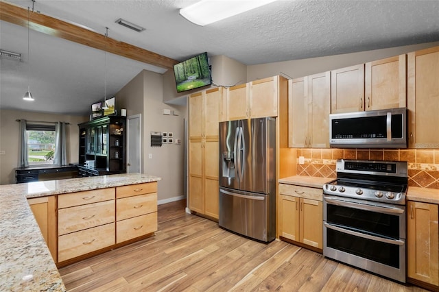 2921 Lake Tohopekaliga Blvd, Kissimmee, FL 34746 - kitchen with stainless steel appliances, light brown cabinets, decorative backsplash, light wood-style flooring, and a textured ceiling