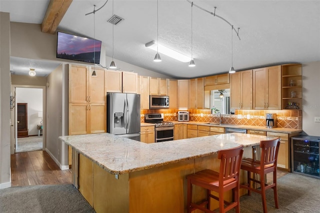2921 Lake Tohopekaliga Blvd, Kissimmee, FL 34746 - kitchen with stainless steel appliances, light brown cabinetry, tasteful backsplash, a kitchen bar, and light stone countertops