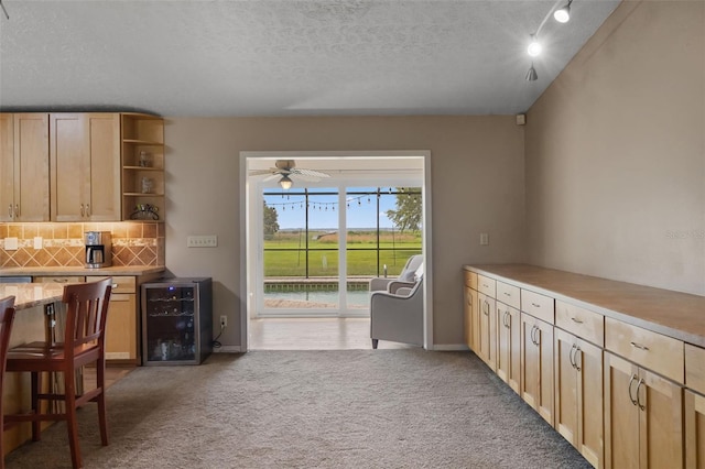 2921 Lake Tohopekaliga Blvd, Kissimmee, FL 34746 - kitchen with wine cooler, open shelves, tasteful backsplash, light carpet, and light countertops