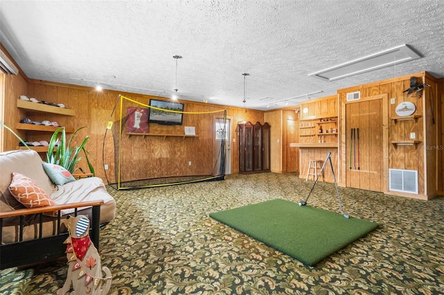 2921 Lake Tohopekaliga Blvd, Kissimmee, FL 34746 - game room featuring wooden walls, attic access, a textured ceiling, and carpet flooring
