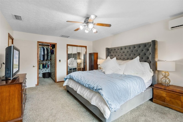2921 Lake Tohopekaliga Blvd, Kissimmee, FL 34746 - bedroom featuring light colored carpet, a wall unit AC, multiple closets, and a ceiling fan