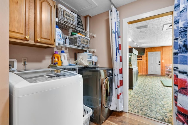 2921 Lake Tohopekaliga Blvd, Kissimmee, FL 34746 - washroom featuring cabinet space, washing machine and dryer, wood finished floors, attic access, and a textured ceiling
