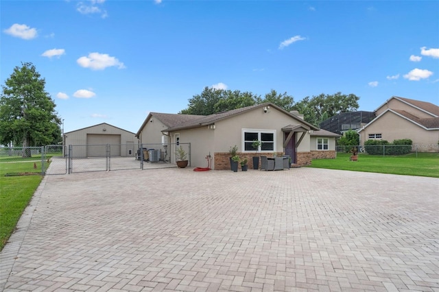 2921 Lake Tohopekaliga Blvd, Kissimmee, FL 34746 - view of front of home with a gate, a detached garage, decorative driveway, stucco siding, and an outdoor structure