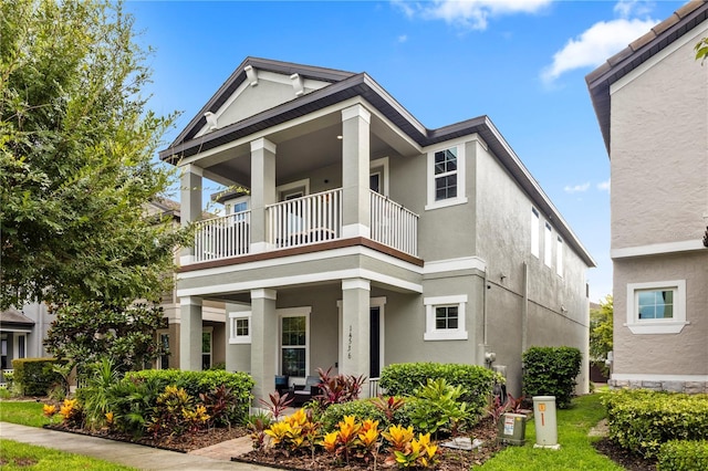 14536 Golden Harbor Ln, Winter Garden, FL 34787 - view of front of home featuring a balcony, a porch, and stucco siding