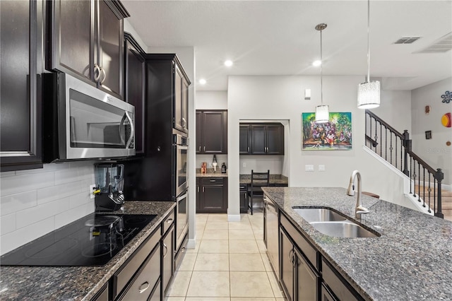 14536 Golden Harbor Ln, Winter Garden, FL 34787 - kitchen featuring stainless steel appliances, dark stone counters, decorative backsplash, decorative light fixtures, and recessed lighting