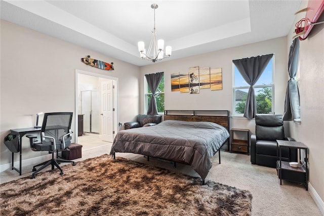 14536 Golden Harbor Ln, Winter Garden, FL 34787 - bedroom featuring light carpet, a chandelier, a raised ceiling, and ensuite bath