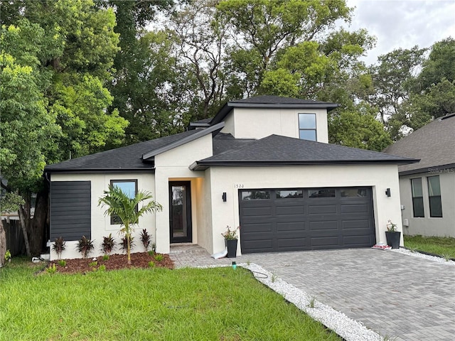 1526 Hempel Ave, Gotha, FL 34734 - view of front facade featuring a garage, decorative driveway, stucco siding, and roof with shingles