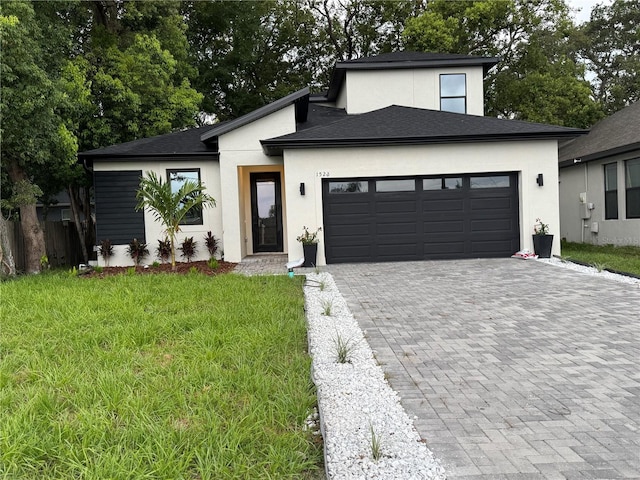 1526 Hempel Ave, Gotha, FL 34734 - view of front facade featuring stucco siding, decorative driveway, a garage, and a front yard