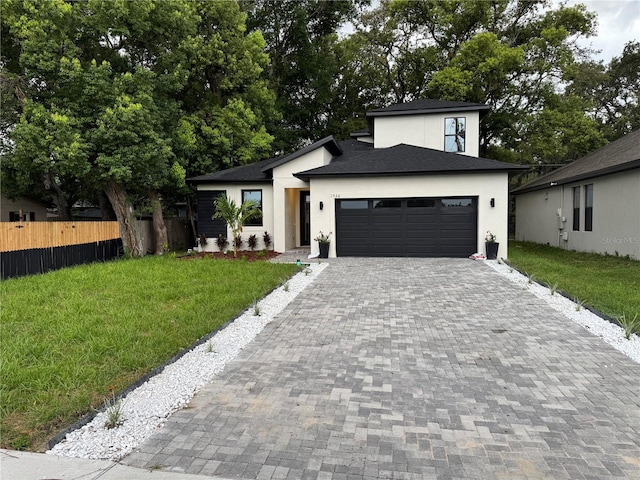 1526 Hempel Ave, Gotha, FL 34734 - view of front of property featuring stucco siding, decorative driveway, a garage, and roof with shingles