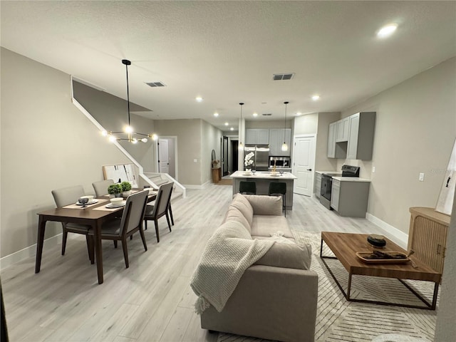1526 Hempel Ave, Gotha, FL 34734 - living room with light wood-style flooring, stairway, and recessed lighting