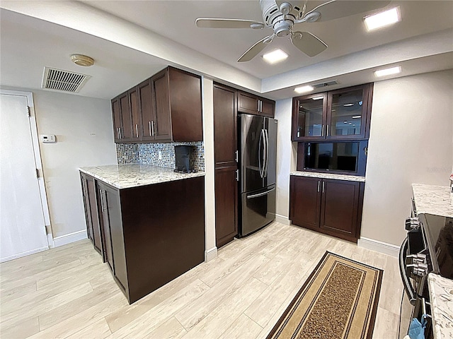 2400 Presidential Way Unit 1104, West Palm Beach, FL 33401 - kitchen featuring freestanding refrigerator, dark brown cabinetry, light wood-type flooring, ceiling fan, and tasteful backsplash