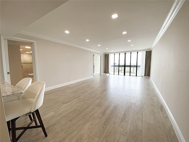 2400 Presidential Way Unit 1104, West Palm Beach, FL 33401 - living room featuring crown molding, light wood-type flooring, expansive windows, and recessed lighting
