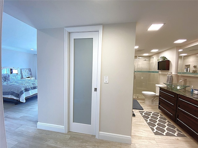 2400 Presidential Way Unit 1104, West Palm Beach, FL 33401 - ensuite bathroom with vanity, a stall shower, and wood finished floors