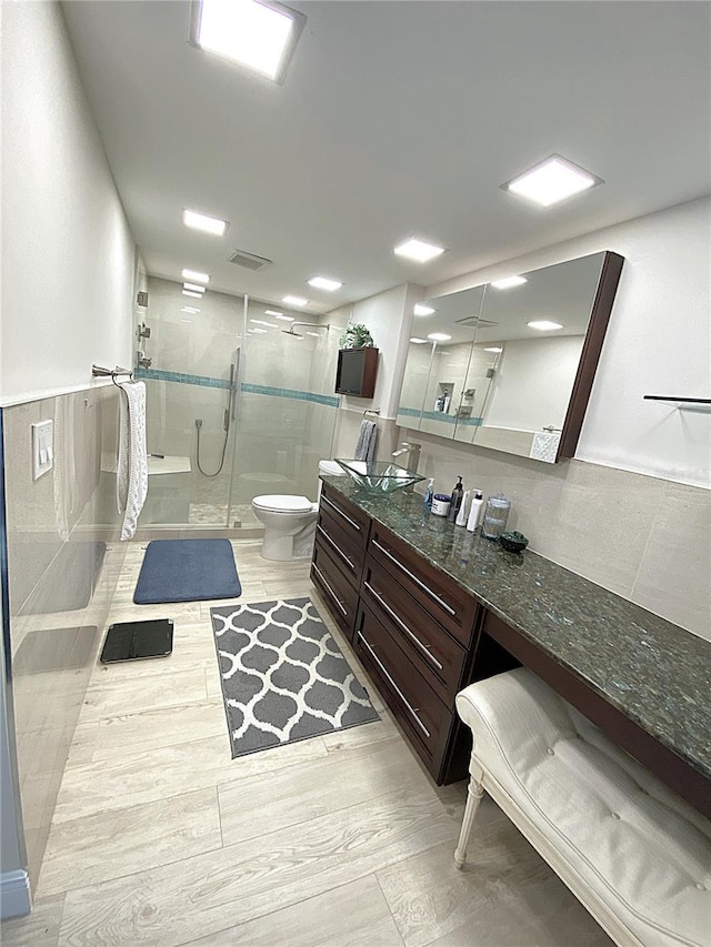2400 Presidential Way Unit 1104, West Palm Beach, FL 33401 - full bath with a shower stall, vanity, and wainscoting