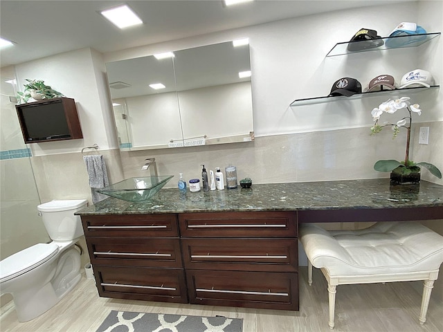 2400 Presidential Way Unit 1104, West Palm Beach, FL 33401 - full bathroom featuring vanity, wood finished floors, and tile walls