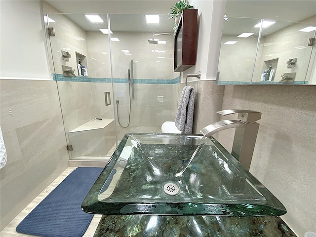 2400 Presidential Way Unit 1104, West Palm Beach, FL 33401 - full bathroom featuring tile walls and a stall shower