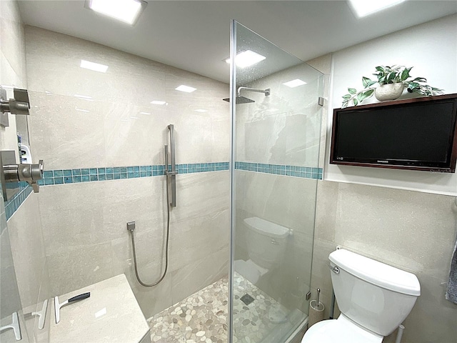 2400 Presidential Way Unit 1104, West Palm Beach, FL 33401 - bathroom with a stall shower and tile walls