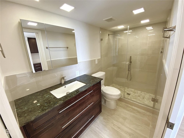 2400 Presidential Way Unit 1104, West Palm Beach, FL 33401 - bathroom with a shower stall, vanity, and tile walls