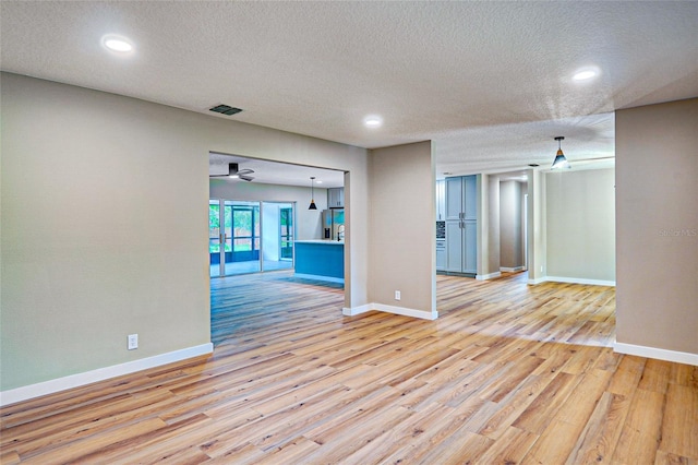 5938 Marlberry Dr, Orlando, FL 32819 - empty room with light wood-style floors, a textured ceiling, and recessed lighting