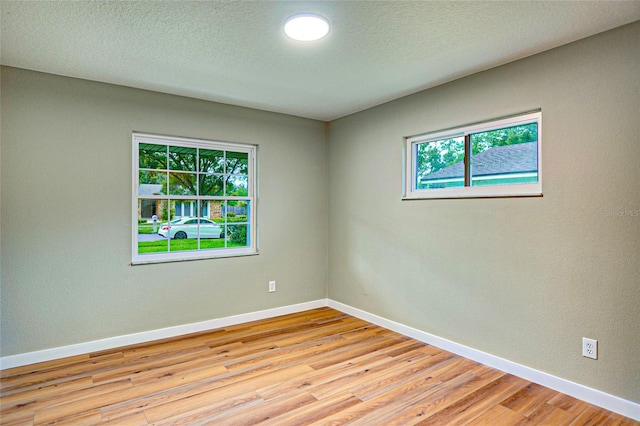 5938 Marlberry Dr, Orlando, FL 32819 - empty room featuring light wood-type flooring and a textured ceiling