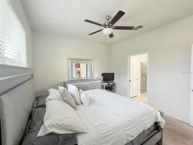 17504 Butterfly Pea Ct, Clermont, FL 34714 - bedroom with light carpet, ceiling fan, and ensuite bathroom