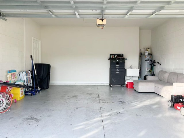 17504 Butterfly Pea Ct, Clermont, FL 34714 - garage featuring strapped water heater, a garage door opener, and concrete block wall