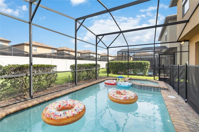 2108 Morocco Way, Kissimmee, FL 34747 - view of swimming pool with a pool with connected hot tub, glass enclosure, and a residential view