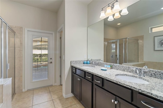2108 Morocco Way, Kissimmee, FL 34747 - bathroom with a stall shower, double vanity, tile patterned floors, and a chandelier