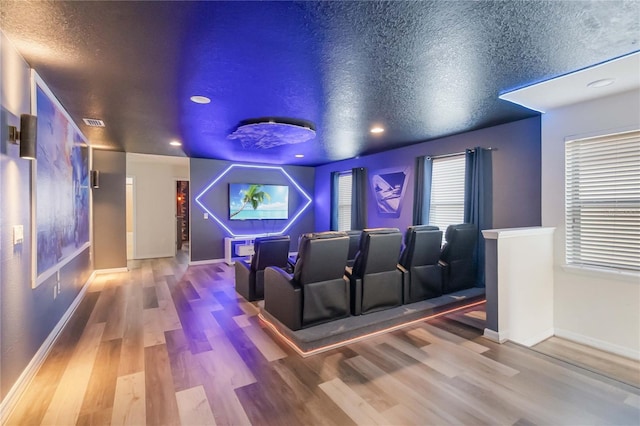 2108 Morocco Way, Kissimmee, FL 34747 - home theater featuring wood finished floors, a textured ceiling, and recessed lighting