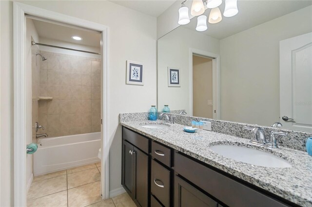 2108 Morocco Way, Kissimmee, FL 34747 - full bath featuring double vanity, tile patterned floors, bathing tub / shower combination, and a chandelier