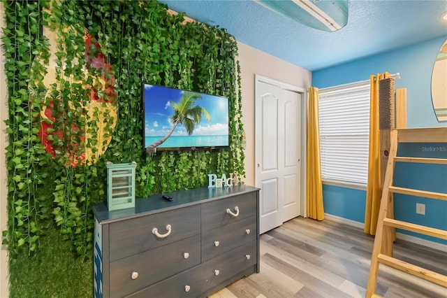 2108 Morocco Way, Kissimmee, FL 34747 - bedroom with light wood-type flooring and a textured ceiling