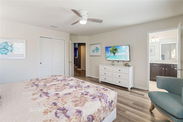 2108 Morocco Way, Kissimmee, FL 34747 - bedroom featuring light wood-style floors, a closet, ensuite bathroom, and a ceiling fan