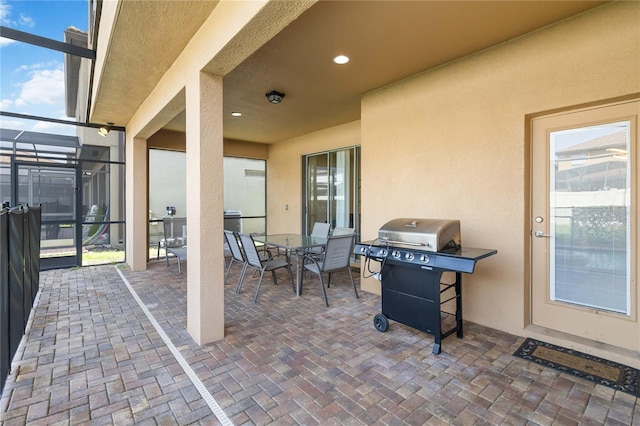 2108 Morocco Way, Kissimmee, FL 34747 - view of patio featuring area for grilling, a lanai, and outdoor dining area