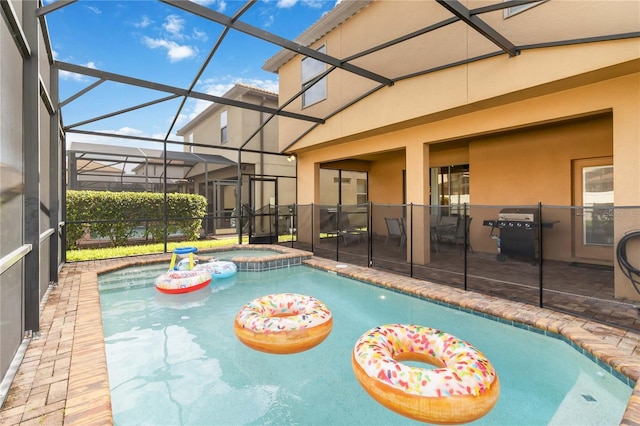 2108 Morocco Way, Kissimmee, FL 34747 - view of pool featuring a patio area, grilling area, a lanai, and a pool with connected hot tub