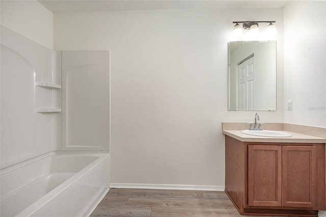 85 Levee Ln, Ormond Beach, FL 32174 - bathroom featuring vanity, wood finished floors, and  shower combination