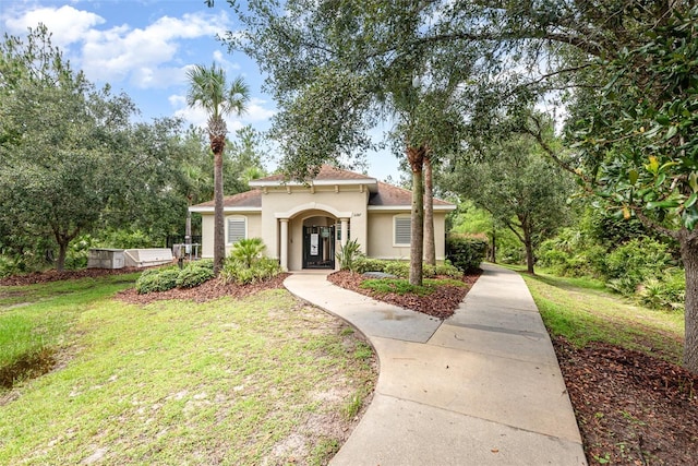 85 Levee Ln, Ormond Beach, FL 32174 - mediterranean / spanish-style house featuring stucco siding and a front lawn